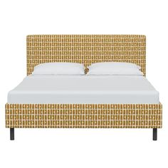 an upholstered bed with white sheets and yellow patterned headboard, made in the usa