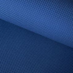 a close up shot of the texture of a blue mesh fabric with small holes on it