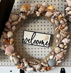 a welcome wreath with seashells on it