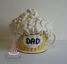 a cupcake shaped like a mug with the word dad written on it's side