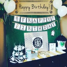 there is a birthday party set up with starbucks items on the table and balloons in the background