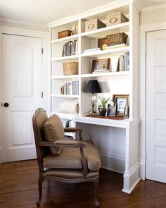 a chair sitting in front of a white book shelf