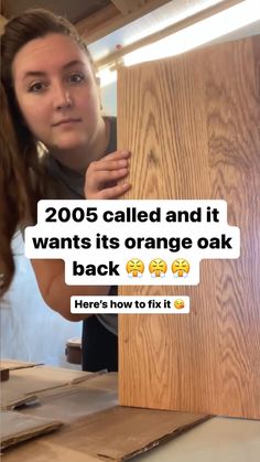 a woman holding up a piece of wood with the caption, 200 called and it wants its orange oak back here's how to fix it