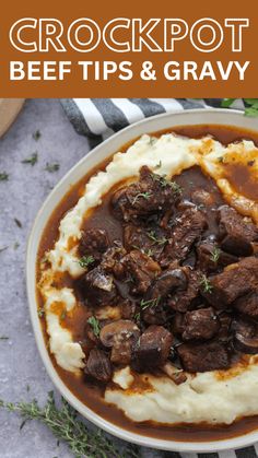 a bowl filled with meat and gravy on top of mashed potatoes