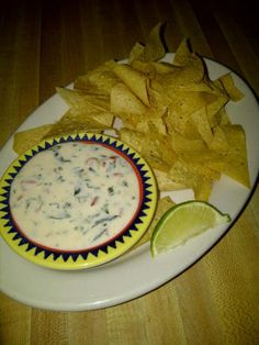 a white plate topped with chips and salsa