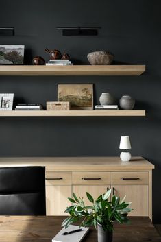 a wooden table topped with a potted plant next to a shelf filled with books