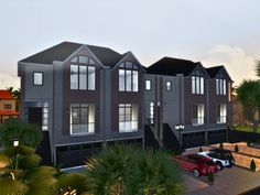 a three story house with cars parked in the driveway