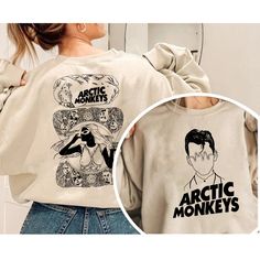 the back of a woman's sweatshirt with an image of arctic monkeys on it