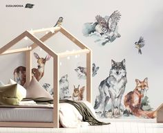 an animal themed wallpaper in a child's room with a bed and toys