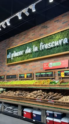 a display in a grocery store filled with lots of fresh produce and vegetables on shelves