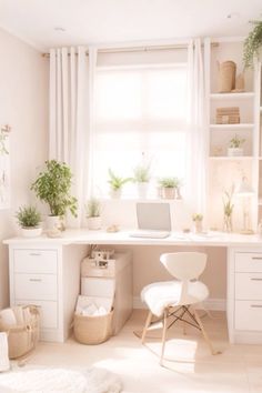 a white desk with a laptop on top of it in a room filled with plants