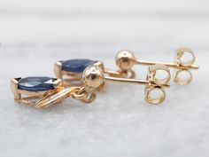 These pretty sapphire gems are a beautiful rich blue that seems to glow from within! We've set these sapphire gems in yellow gold. The marquise cut with diamond accents makes for a sophisticated look. These drop earrings are truly breathtaking, ready to wear or gift!Metal: 14K Yellow GoldGem: 2 Sapphires totaling .65 CaratsGem Measurements: 3.1 x 7.5 mm, Marquise Cut Accents: 4 Diamonds totaling .02 Carats, SI in Clarity, H-I in Color Earrings Length: 15 mmEarrings Width: 6 mm 14k Gold Marquise Cut Earrings For Formal Occasions, Marquise Sapphire Jewelry With Diamond Cut, Formal Marquise Sapphire Jewelry, Formal 14k Gold Marquise Cut Earrings, Formal Yellow Gold Marquise Cut Earrings, Gold Sapphire Earrings With Prong Setting, Gold Sapphire Marquise Cut Jewelry, Blue Marquise Earrings For Anniversary, Sapphire Marquise Cut Gemstone Jewelry