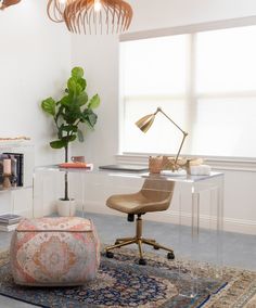 an office with a desk, chair and rug