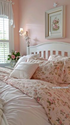 a bedroom with pink walls and white bedding has flowers on the pillowcases