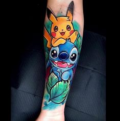 a person with a tattoo on their arm that has an image of pikachu