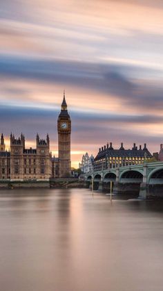 the big ben clock tower towering over the city of london, england at sunset or dawn