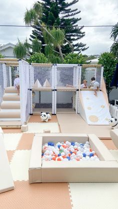 an outdoor play area with balls and slides