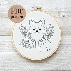 an embroidery pattern with a fox and leaves on it