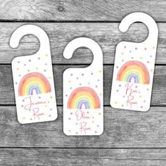 three baby bibs with rainbows on them