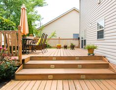 a wooden deck with steps leading up to an umbrella