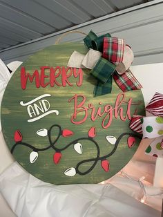 a merry and bright sign hanging from the side of a wall next to christmas decorations