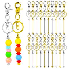 several different types of key chains with beads on each side and one has a ball in the middle