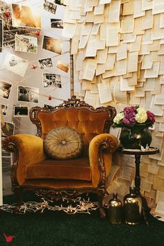 an old chair sitting in front of a wall covered with papers