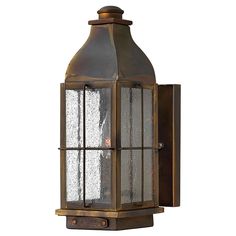 an old fashioned wall light with glass panels on the front and back side, against a white background