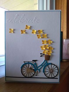 a card with a bicycle and flowers on it