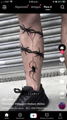 the legs and ankles of a man with barbed wire tattoos on them, are shown