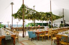 an outdoor tent set up with tables and chairs