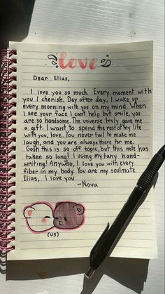 a note with an elephant drawn on it next to a fountain pen and paper that says love