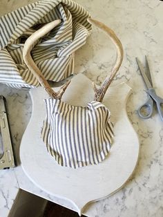 a purse sitting on top of a counter next to scissors