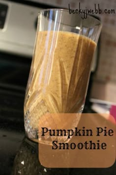 pumpkin pie smoothie in a glass on top of a counter with text overlay