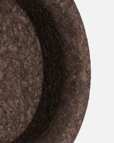 a close up view of a circular object made out of rocks and dirt on a white background