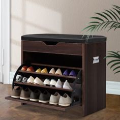 the shoe cabinet bench has three tiers for shoes and two bins for shoes