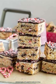 chocolate peppermint rice krispy treats stacked on top of each other with candy canes