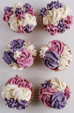 cupcakes with purple and white frosting on them