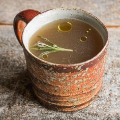 a cup filled with soup sitting on top of a table