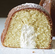 a half eaten piece of cake sitting on top of a white plate next to a bundt cake