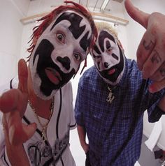 two people with painted faces making the peace sign