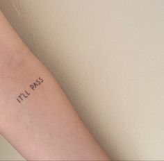 a person with a tattoo on their arm that says it'll pass in black ink