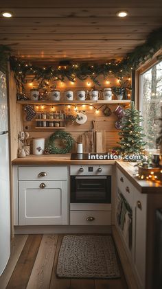 a kitchen decorated for christmas with lights and garland