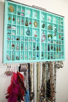 a wall mounted jewelry rack with lots of bracelets