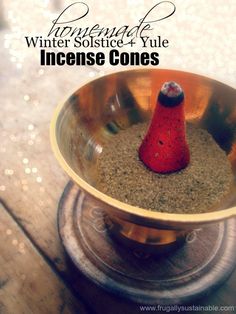 a small red cone sitting in a bowl on top of a wooden table with words above it