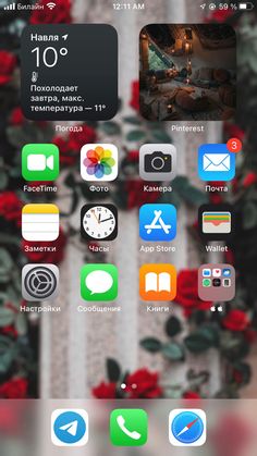 the home screen of an iphone with various icons on it and flowers in the background