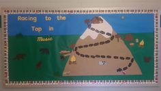 a bulletin board with an image of a mountain and road in the middle that says, racing to the top in music