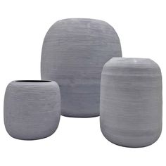 three grey vases sitting next to each other