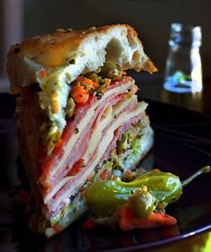 a sandwich cut in half sitting on top of a black plate