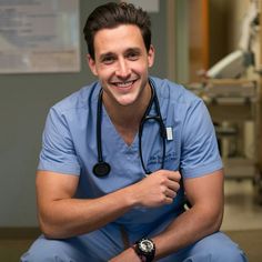 a smiling man with a stethoscope around his neck